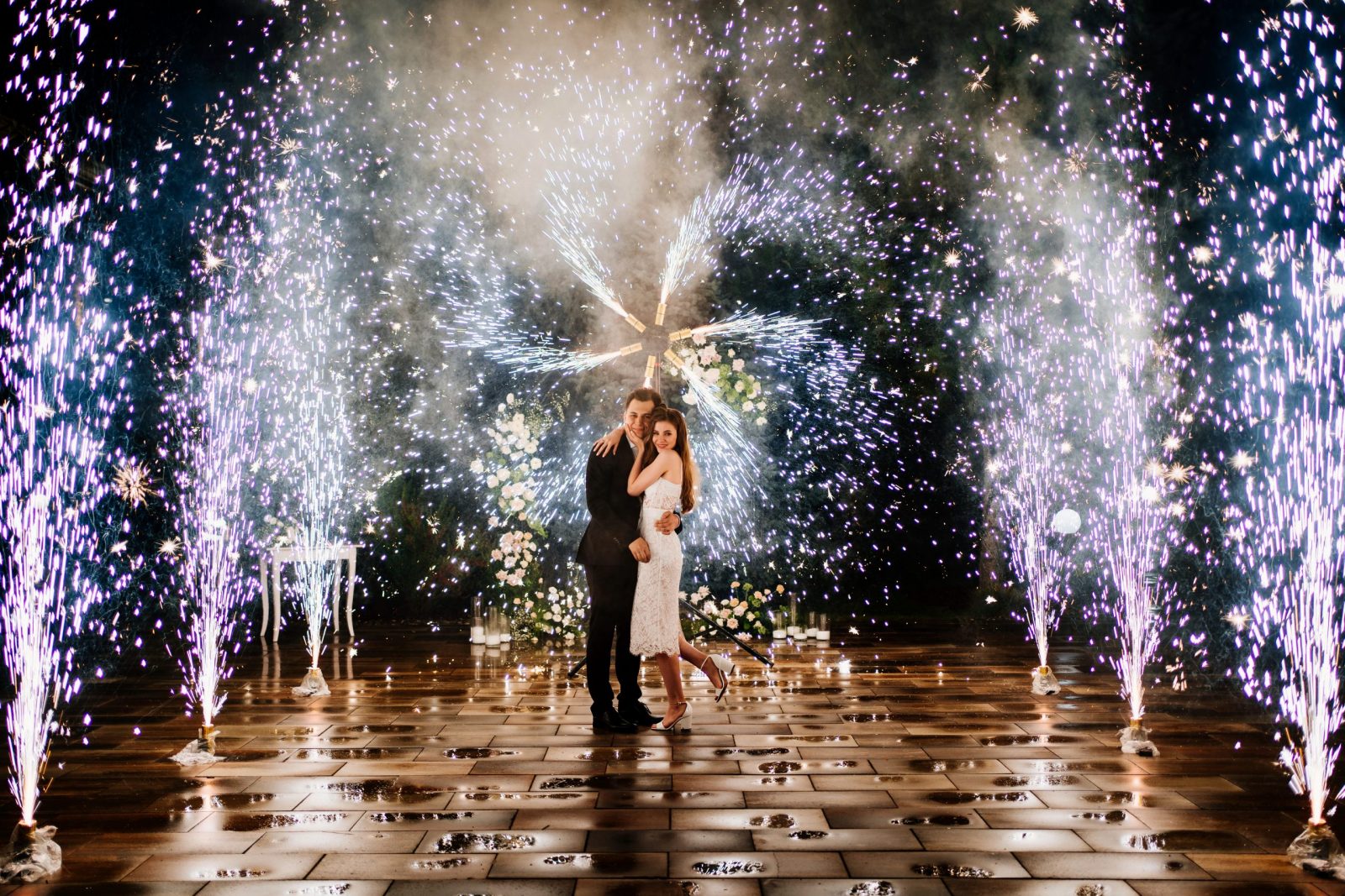 bride and groom are standing in the hallway of the fountains of the fireworks